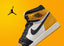 Zapatilla alta Air Jordan 1 en color amarillo, blanco y negro.