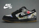 Zapatilla Nike SB Dunk Low con gamuza negra y un patrón gráfico colorido.